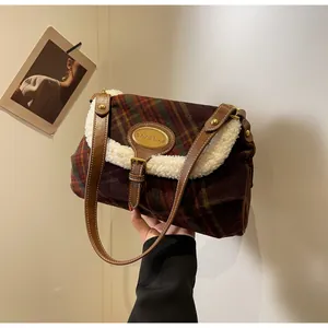 Detail of vintage plaid shoulder bag featuring soft faux fur trim and gold metal logo