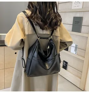 Detailed back view of a large black faux leather bucket backpack worn by a model