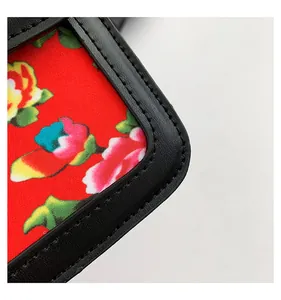 Close-up of floral fabric detail and precise stitching on a Chinese style crossbody bag