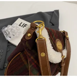 Detail of wool plaid shoulder bag with faux fur trim and vintage golden buckle