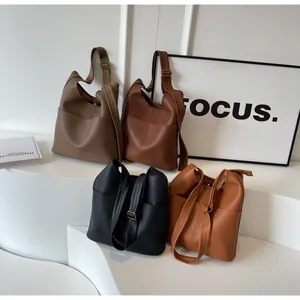Litchi pattern leather bucket bags in brown, khaki and black with adjustable gold buckles