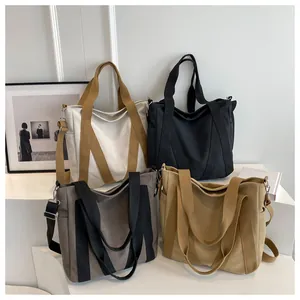 Detail of four colorful canvas tote bags with M-shaped webbing and side pockets