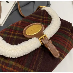 Close-up of retro plaid handbag featuring plush faux fur trim and gold metal buckle