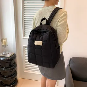 Minimalist black quilted puffer backpack with diamond pattern for casual daily wear