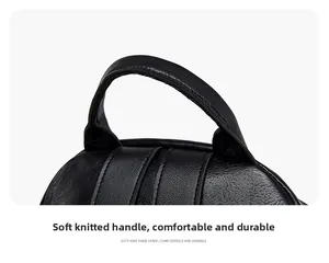 Detail of the soft knit handle on a black textured leather travel backpack for women