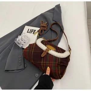 Detail of retro plaid underarm bag featuring white faux fur trim and leather strap