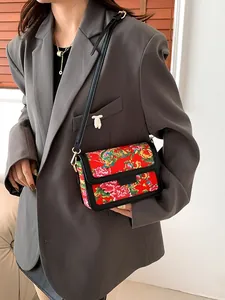 Chinese dragon floral pattern crossbody bag with red fabric and black leather trim for women