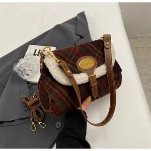 Detail of wool plaid shoulder bag with soft fleece trim and gold-tone metal buckle