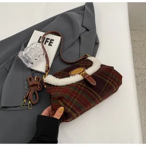 Close-up of retro plaid shoulder bag featuring white faux fur trim and brown leather strap