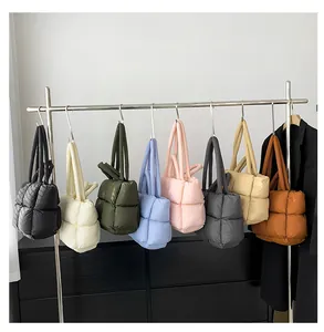 Detailed display of puffer tote bags in eight colors hanging on a silver rack