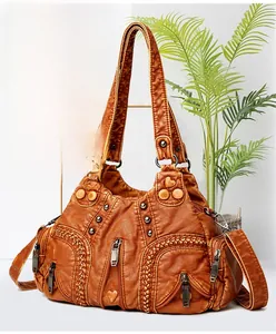 Macro view of vintage brown leather handbag with woven textures and metal rivets