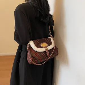 Retro plaid shoulder bag with red-green pattern and faux fur trim worn by a model