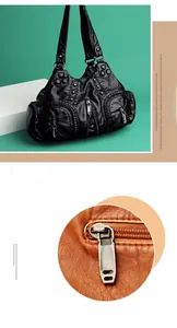 Detailed macro view of high-quality metallic zippers and hardware on washed leather bag