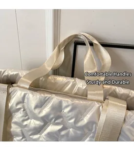 Detail of quilted puffer tote bag with reinforced handles and secure metal zipper