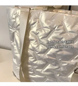 Detailed close-up of soft quilted texture on a stylish white oversized puffer tote bag