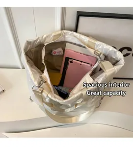 Interior view showing the large storage capacity of the white quilted puffer tote bag