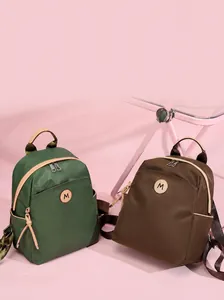 Detailed view of lightweight oxford cloth backpacks in green and brown with contrast trim