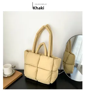 Detail view of khaki quilted puffer tote bag with long and short shoulder straps