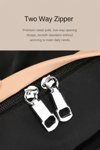 Detail of high-quality silver metal two-way zippers on a black oxford travel backpack