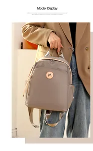 Close-up of lightweight oxford fabric backpack with leather logo patch on stylish model