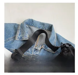 Close-up of durable black nylon shoulder bag with wide fabric strap and drawstring