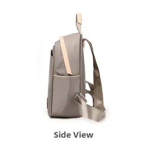 Vista lateral de la mochila gris de nailon impermeable con perfil delgado y bolsillo lateral