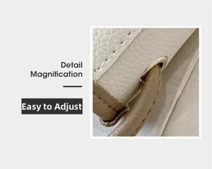 Détail du sac seau en cuir avec bandoulière réglable et anneaux métalliques