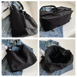 Detailed views of a black nylon tote bag showing drawstring closure and spacious interior