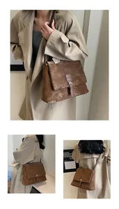 Detailed views of the brown vintage messenger bag with leather buckle and textured finish