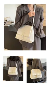 Detail view of cream white crossbody bag with premium leather texture and flap closure