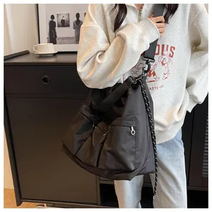 Detailed view of black nylon crossbody bag with functional pockets and adjustable strap