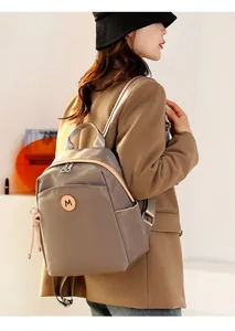 Grey Oxford fabric backpack with leather M logo patch and silver double zippers