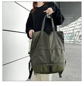 Detailansicht des olivgrünen Nylonrucksacks mit verstärkten Tragegriffen und Taschen