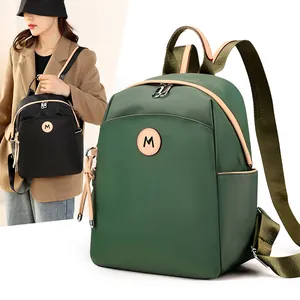 Waterproof nylon backpack in green and black with large capacity for travel and leisure