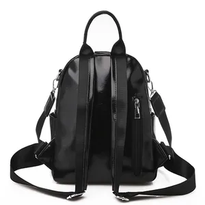 Sac à dos mode en cuir PU noir brillant pour femme avec bretelles réglables et style épuré