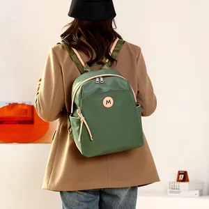 Deep green lightweight nylon backpack for women with large capacity and M logo detail