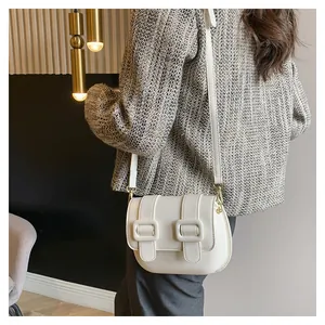Side view of white crossbody square bag with decorative straps on high-quality PU leather