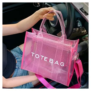 Detail of pink transparent mesh PVC tote bag with letter print and nylon shoulder strap