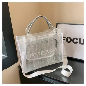 Detail showing white mesh tote bag with removable lettered inner pouch and wide strap