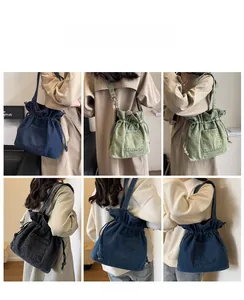 Detail view of denim drawstring bucket bag with pleated ruffles and shoulder strap