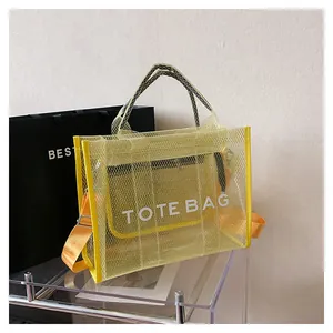 Detail of yellow mesh tote bag with detachable orange strap and Tote Bag print