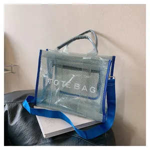 Close-up of blue mesh tote bag with white TOTE BAG lettering on a leather seat
