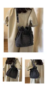 Three-way view of a dark denim drawstring bucket bag worn with a chic beige trench coat