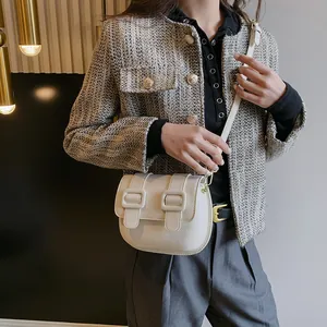 Elegant white leather crossbody bag with flap and dual buckle closures for women