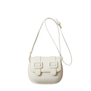 Chic cream PU leather crossbody saddle bag with dual square buckles and gold hardware