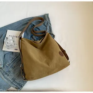 Detailed view of khaki large tote bag with adjustable strap and vintage logo patch