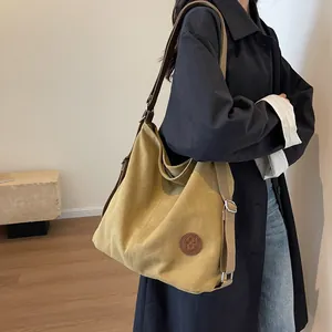 Retro oversized canvas tote bag in mustard yellow with adjustable strap and metal hardware