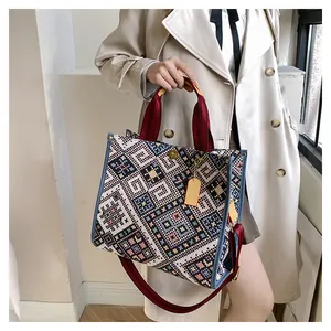 Close-up of geometric woven pattern and blue leather trim on this ethnic tote bag