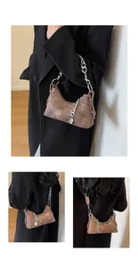 Detailed close-up of retro brown hobo bag with cracked texture and silver chain