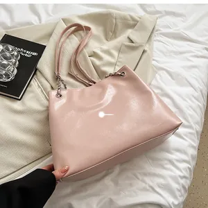 Pink tote bag back view with metal chain strap on minimalist bedroom background